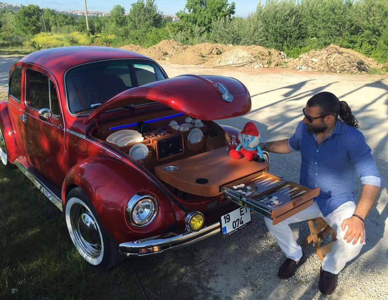 It’s so rare to come across an image that really has it all: Beetles, backgammon, Smurfs, man-ponytails, chrome. Astounding.
